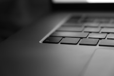 a black and white photo of a laptop keyboard