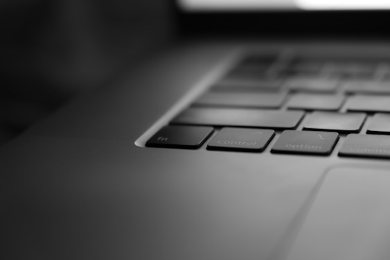 a black and white photo of a laptop keyboard