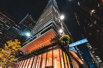 a tall building with a street sign in front of it