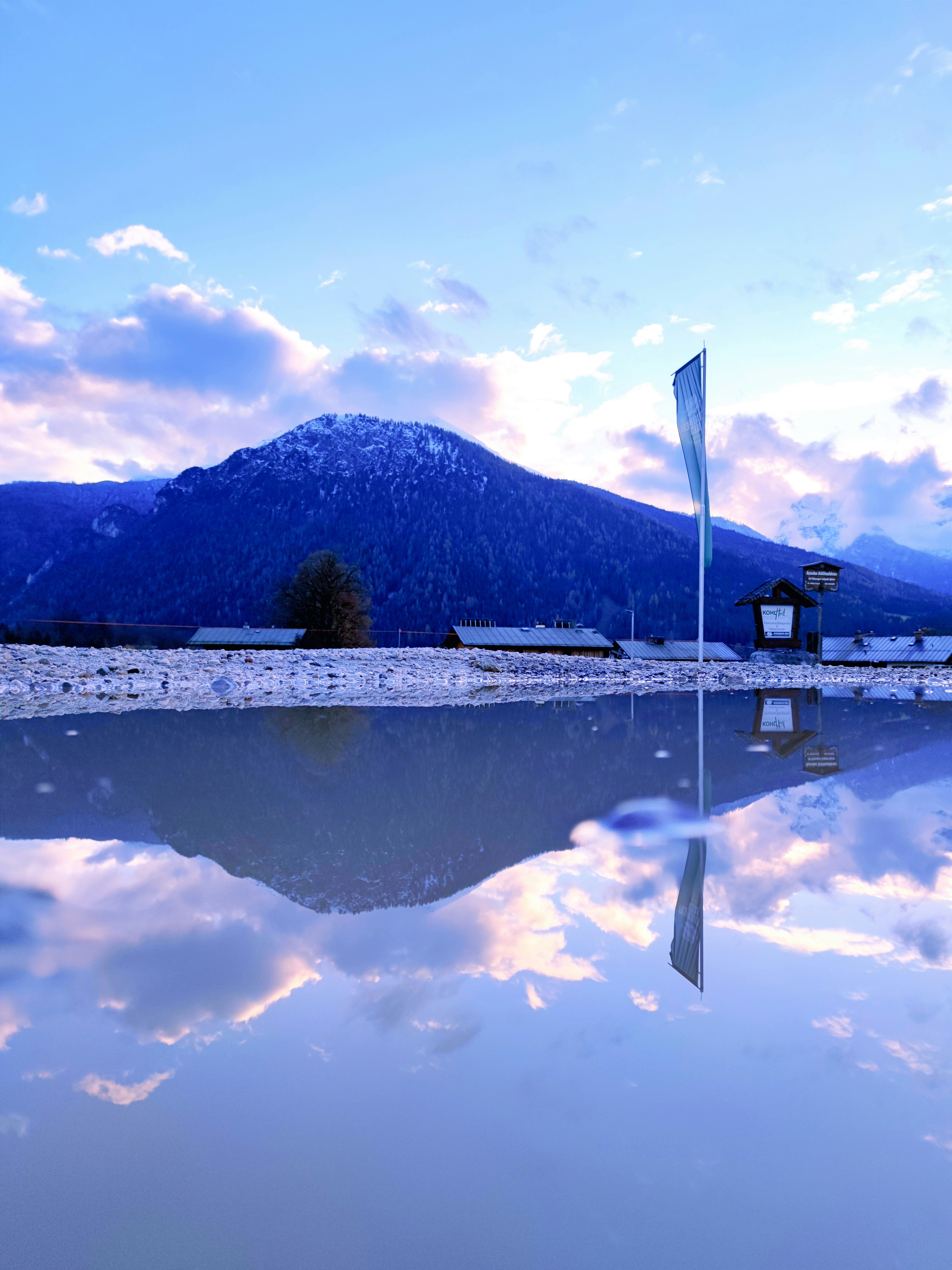 a large body of water with a mountain in the background