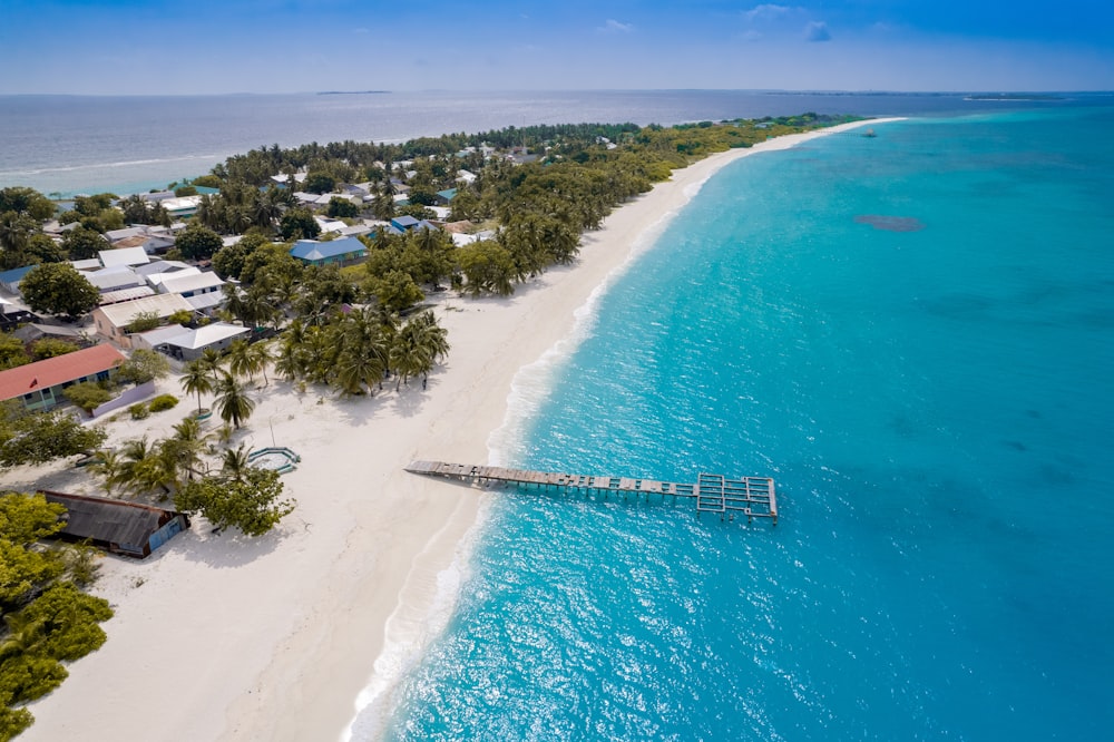 an aerial view of a beach with a pier