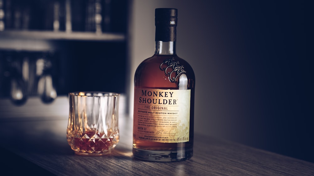 a bottle of monkey shoulder next to a glass