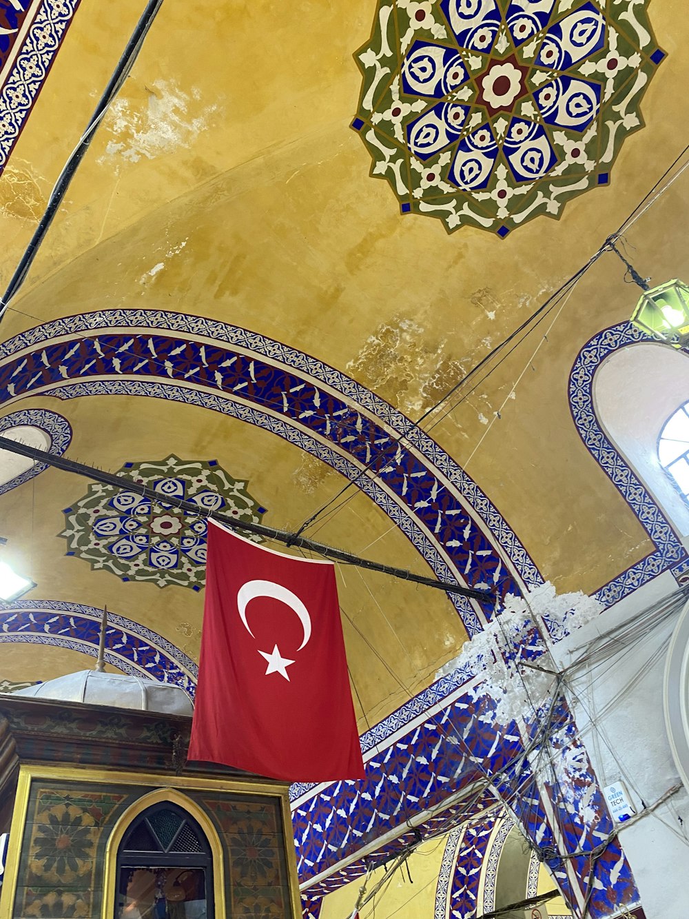 a flag hanging from the ceiling of a building