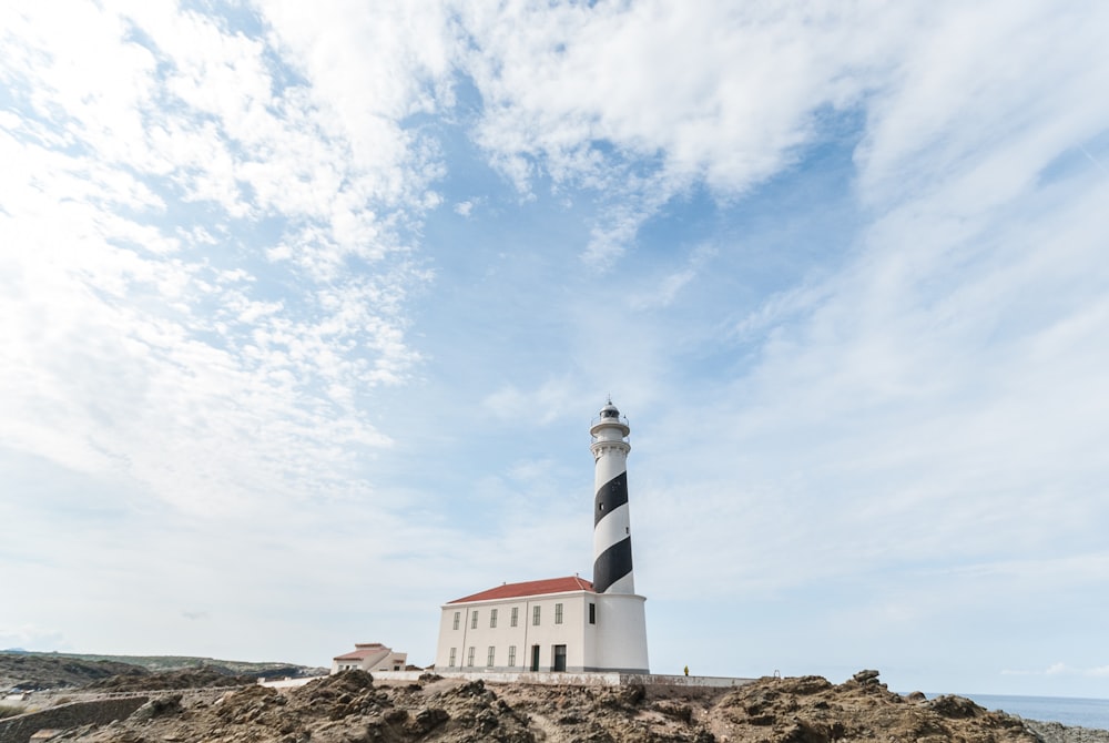 a lighthouse on top of a rocky outcropping