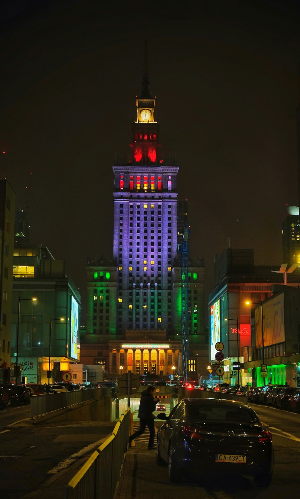 a tall building with a clock tower lit up at night