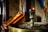Close-up image of a candle burning next to an icon in a traditional Orthodox style.