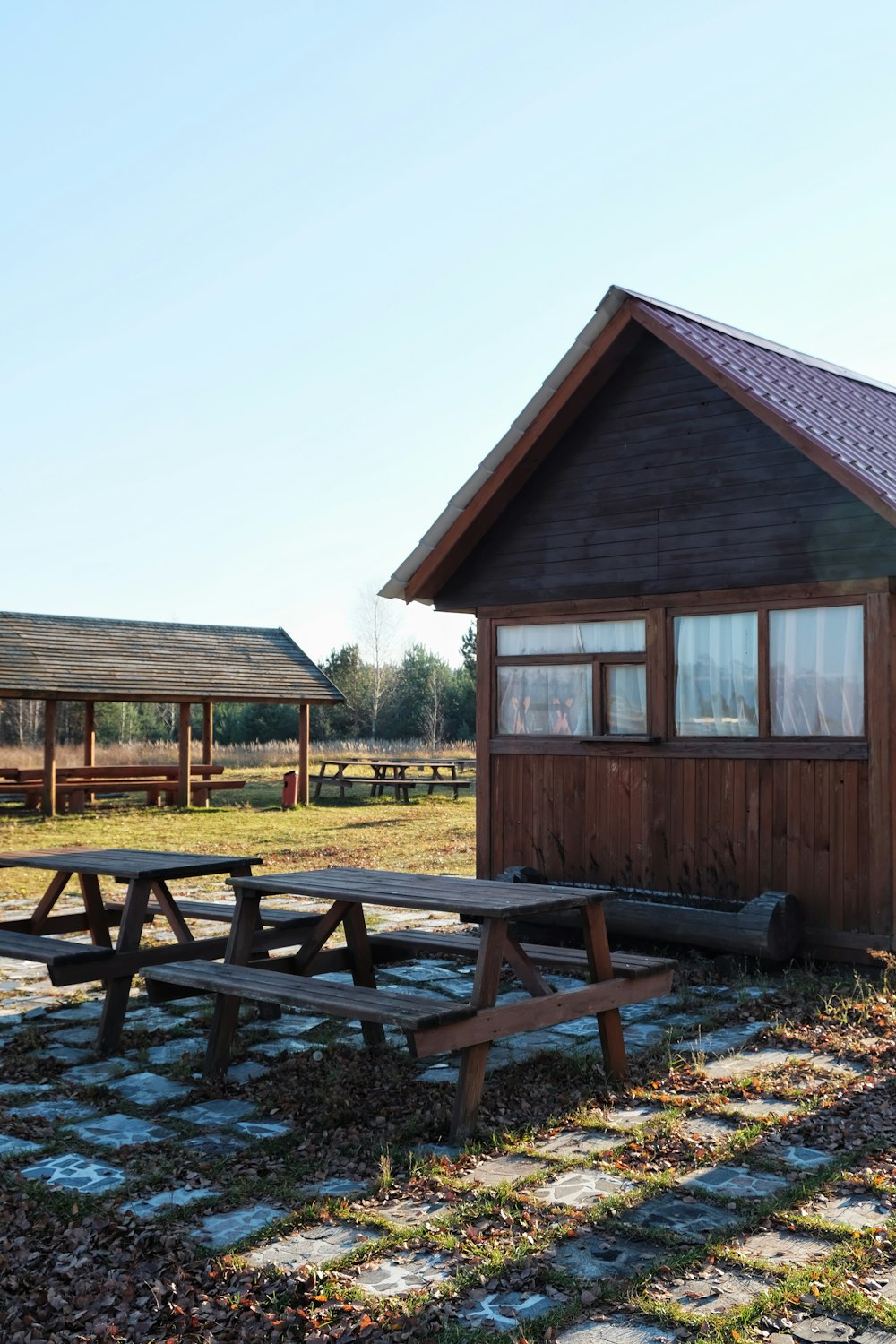 a picnic table in front of a small cabin