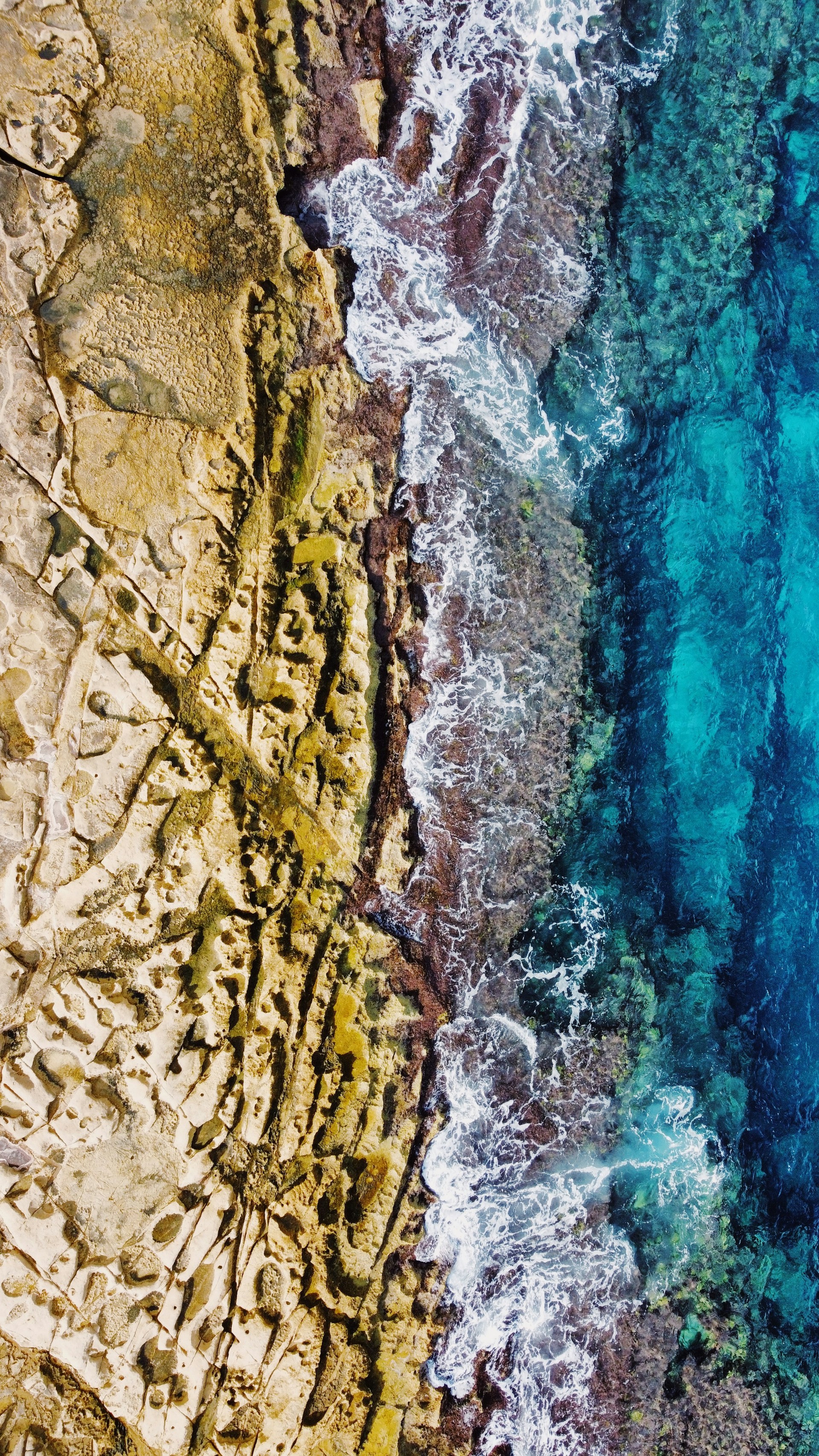 an aerial view of the ocean and land