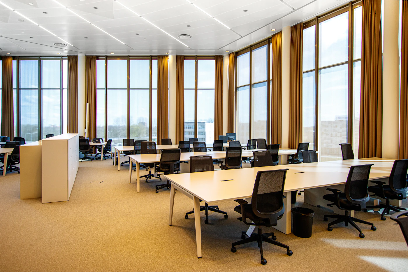 Modern commercial interior with floor-to-ceiling curtains