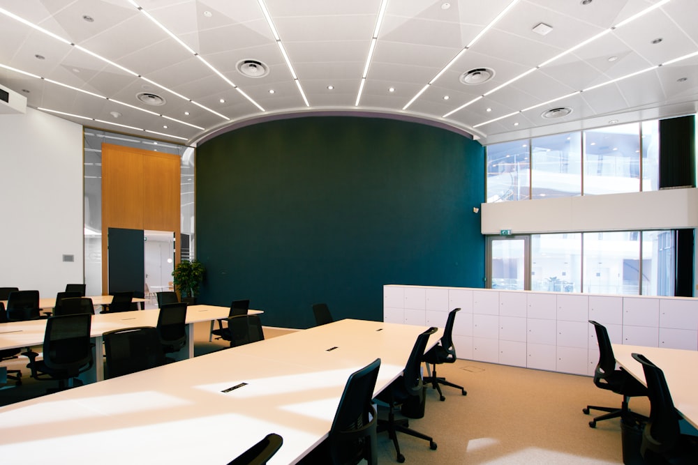 an empty conference room with desks and chairs