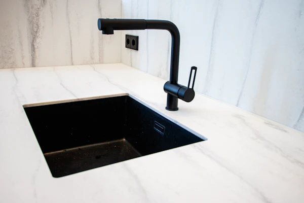 Sleek modern bathroom faucet with a matte black finish reflecting contemporary luxury.