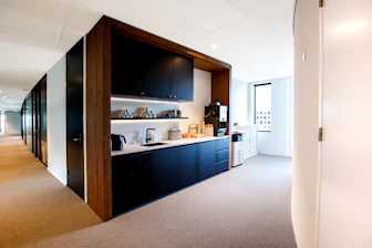 a kitchen with black cabinets and a white counter top