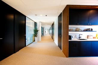 a long hallway leading to a kitchen and dining area
