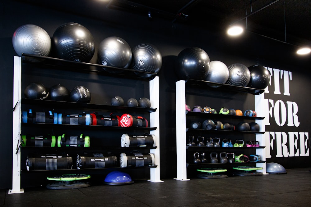 a gym with a wall full of exercise balls