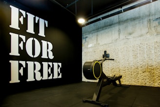a black wall with a sign that says fit for free