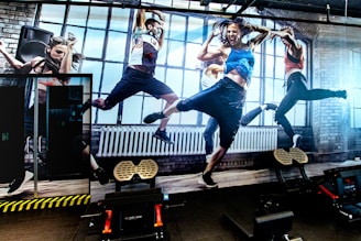 a group of people jumping on top of a treadmill