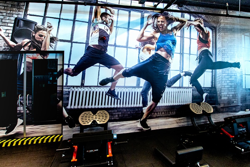 a group of people jumping on top of a treadmill