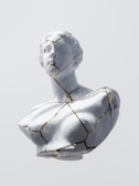 Elegant off-white decorative sculpture with gold matte accents.