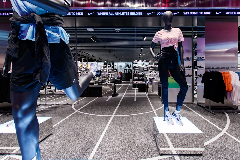 two mannequins dressed in sports clothing in a store