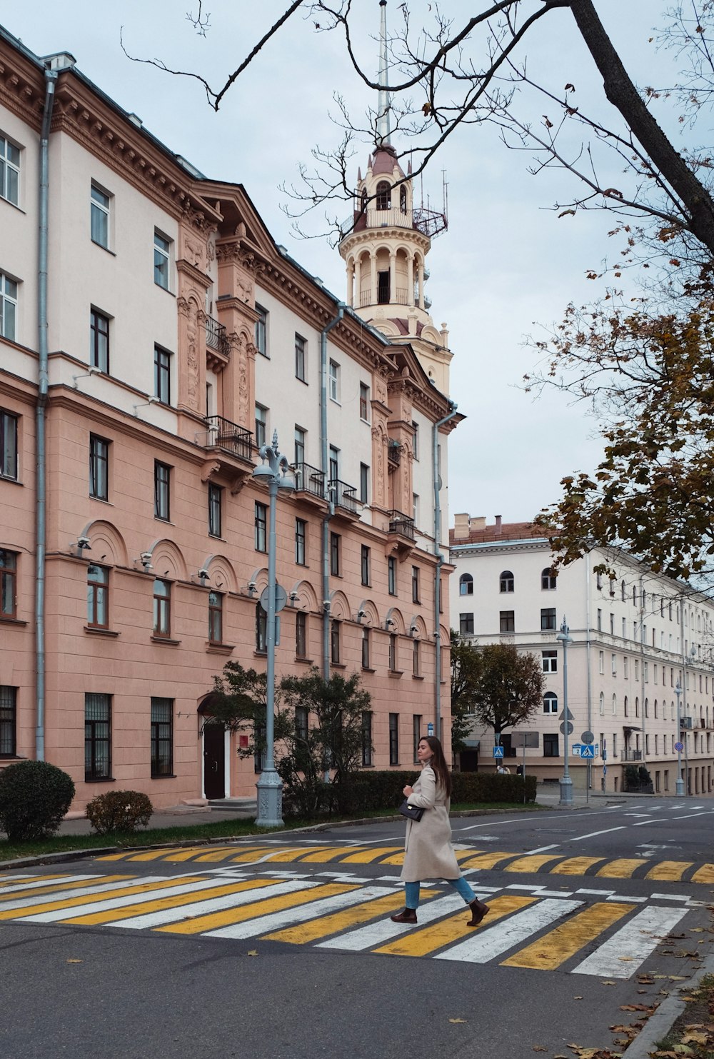 a person walking down a street next to a building