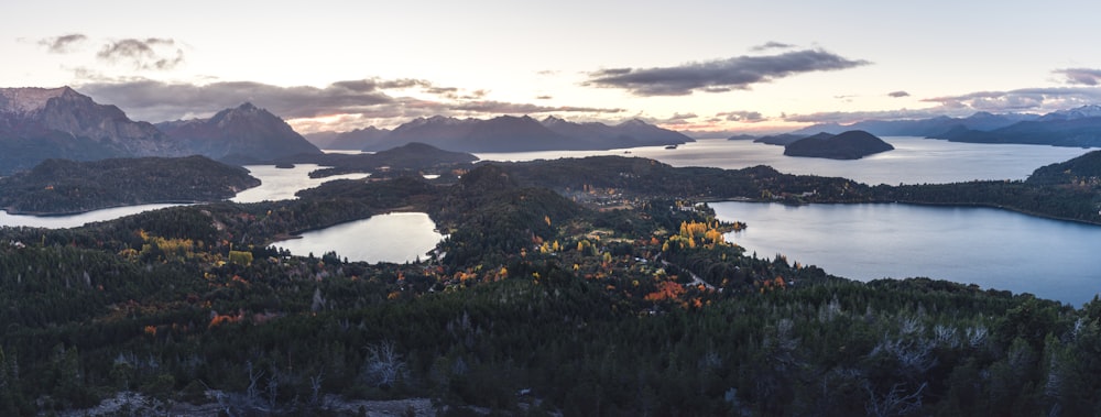 an aerial view of a lake surrounded by mountains