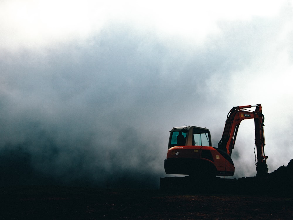 a bulldozer in the middle of a field on a cloudy day