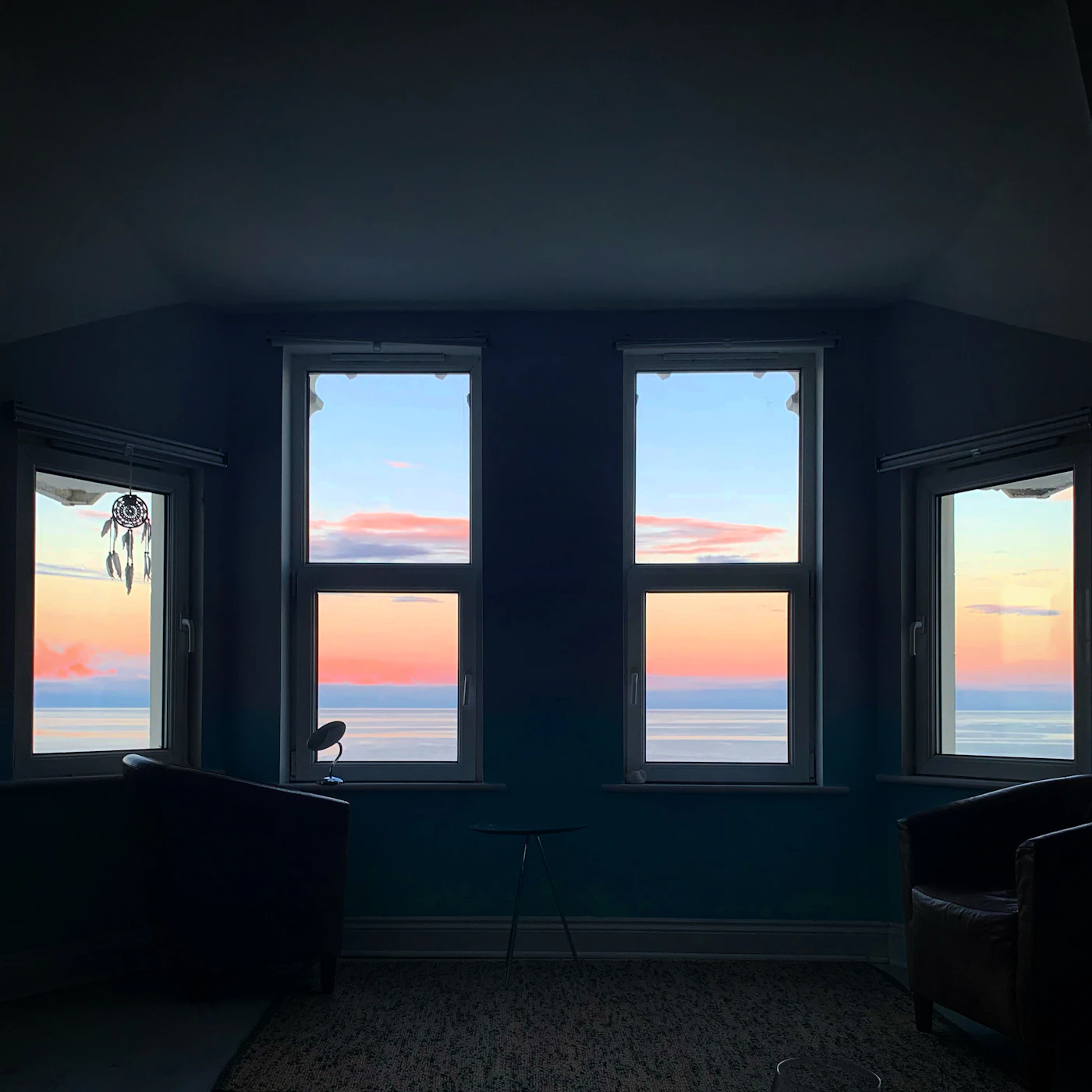Penthouse living room with panoramic ocean view windows