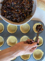 Artisan carefully packing pistachio-filled maamoul with delicate hands.