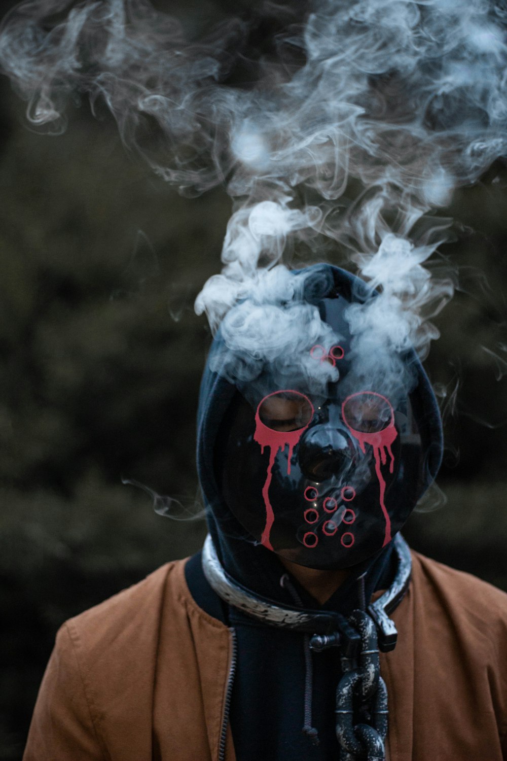 a man wearing a mask with smoke coming out of it