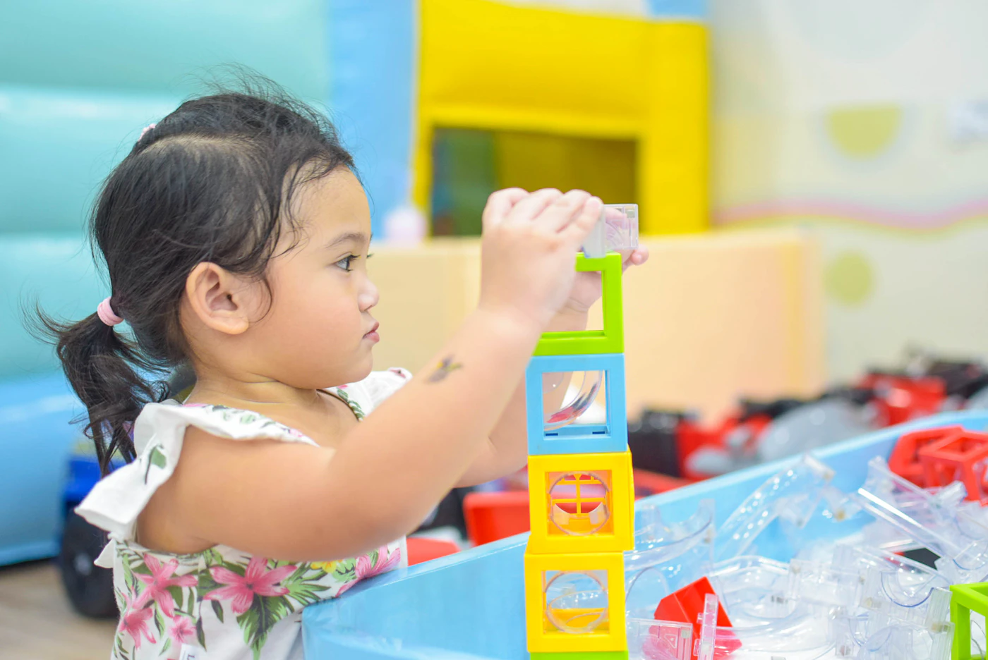 A toddler building with colorful blocks