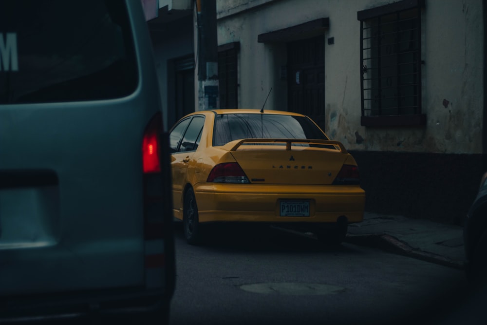 a yellow taxi cab parked on the side of a street