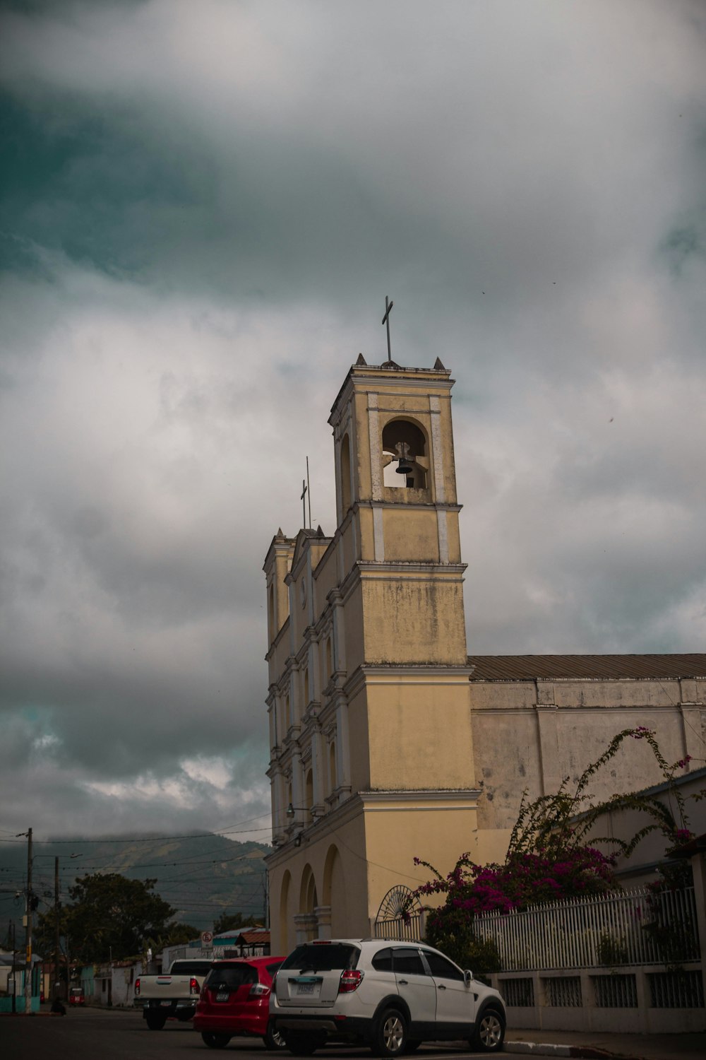 a church with a bell tower on a cloudy day