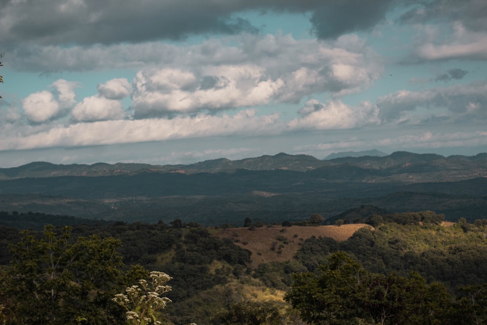 a view of a mountain range with clouds in the sky