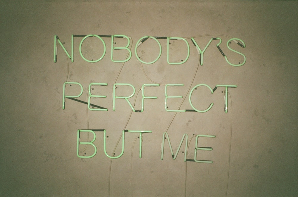 a neon sign that says nobody's perfect but me