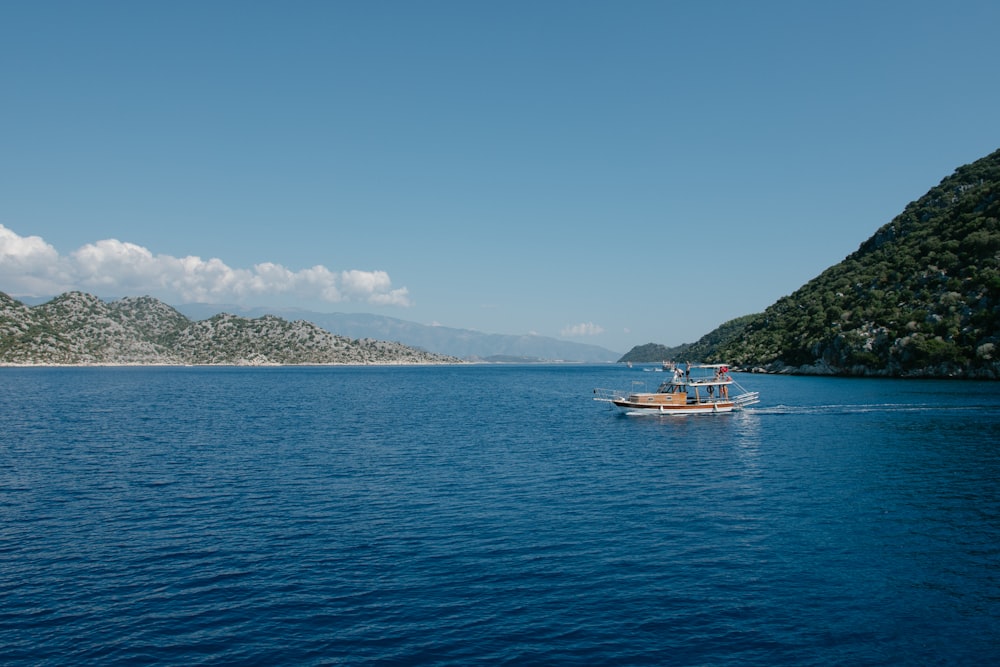 a small boat in the middle of a large body of water