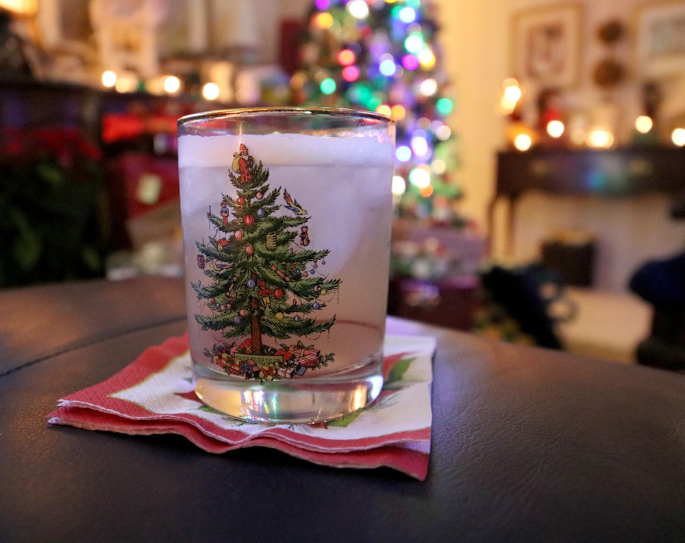 a glass with a christmas tree on it