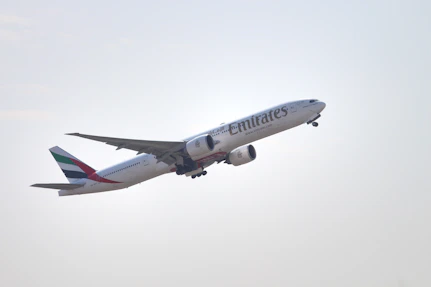 a large jetliner flying through a cloudy sky