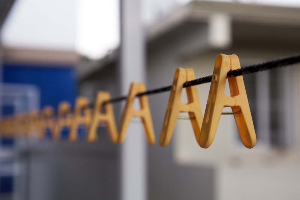 a wooden sign hanging on a rope in front of a building