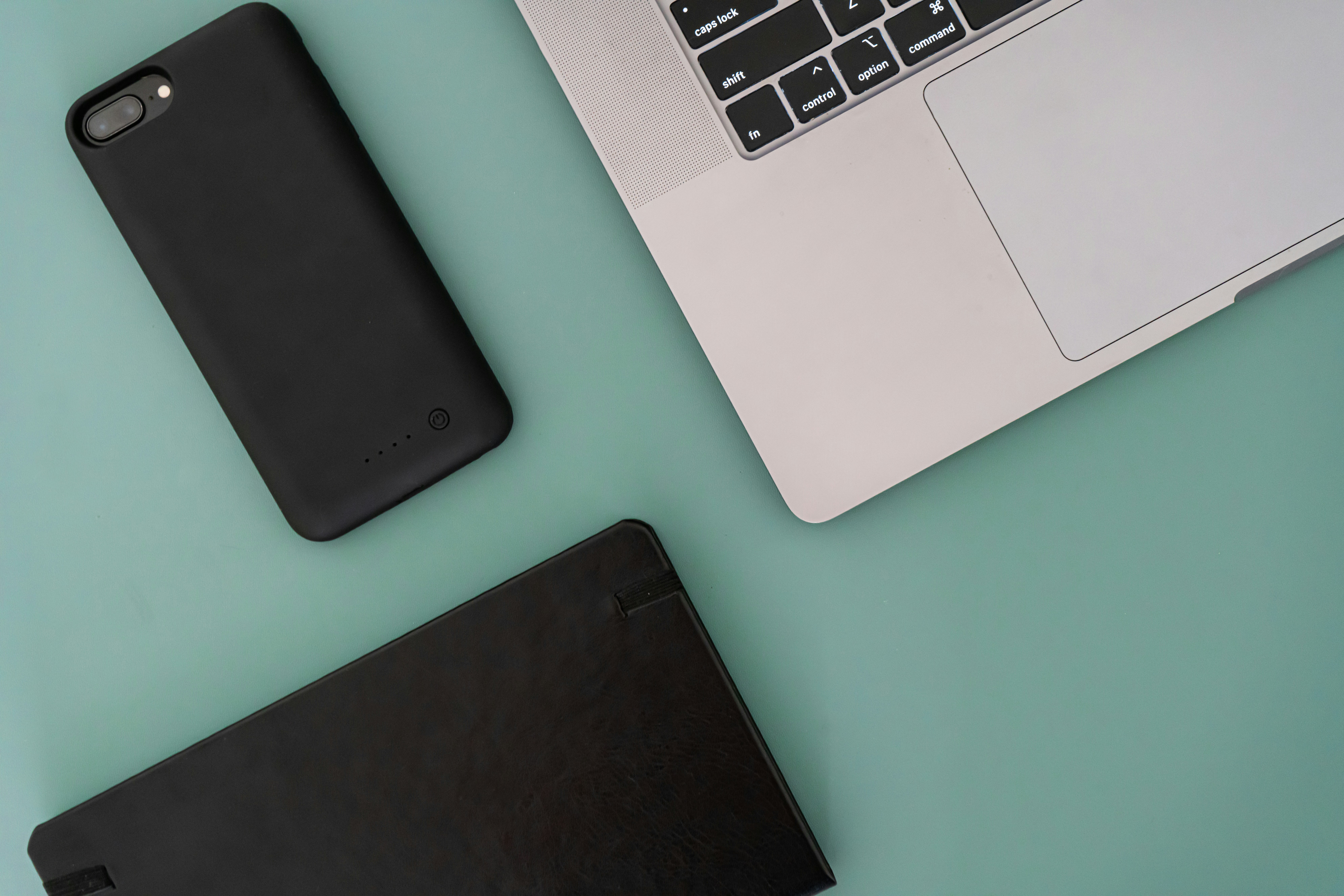 a laptop computer sitting next to a battery case