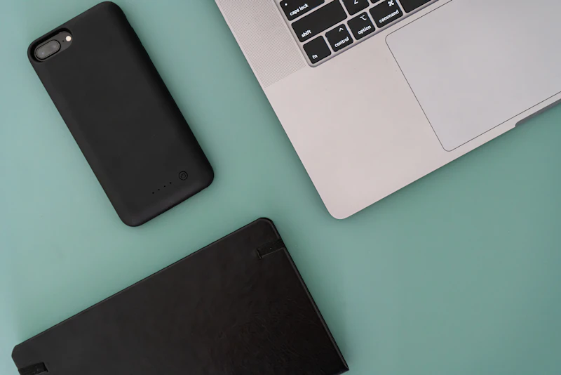 A laptop computer sitting next to a battery case