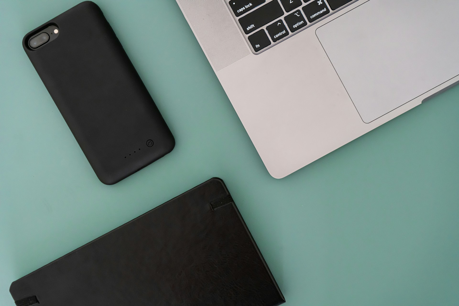 a laptop computer sitting next to a battery case