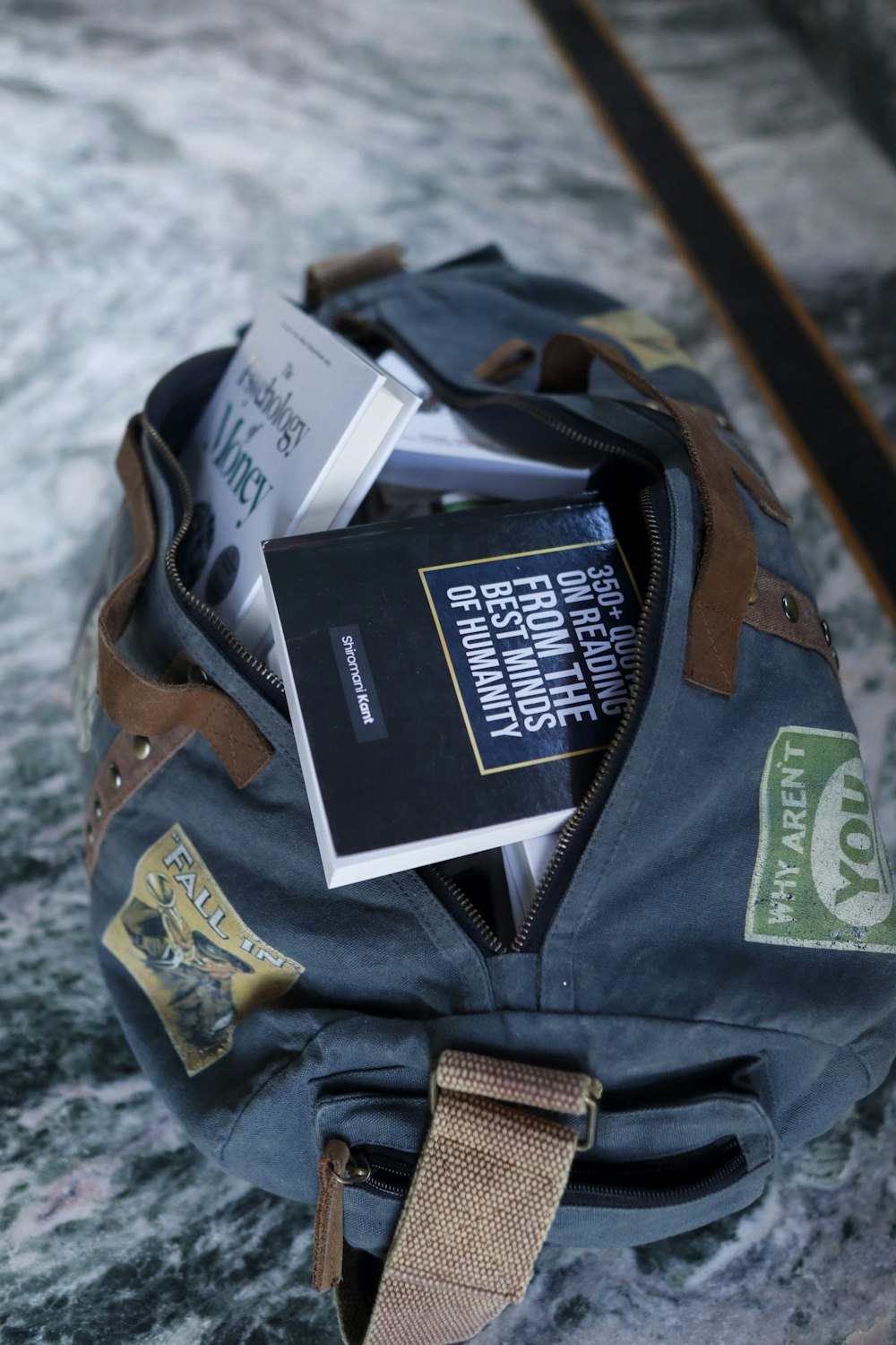 a backpack filled with books sitting on top of a marble floor