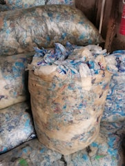a pile of bags filled with blue and white bags