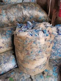 a pile of bags filled with blue and white bags