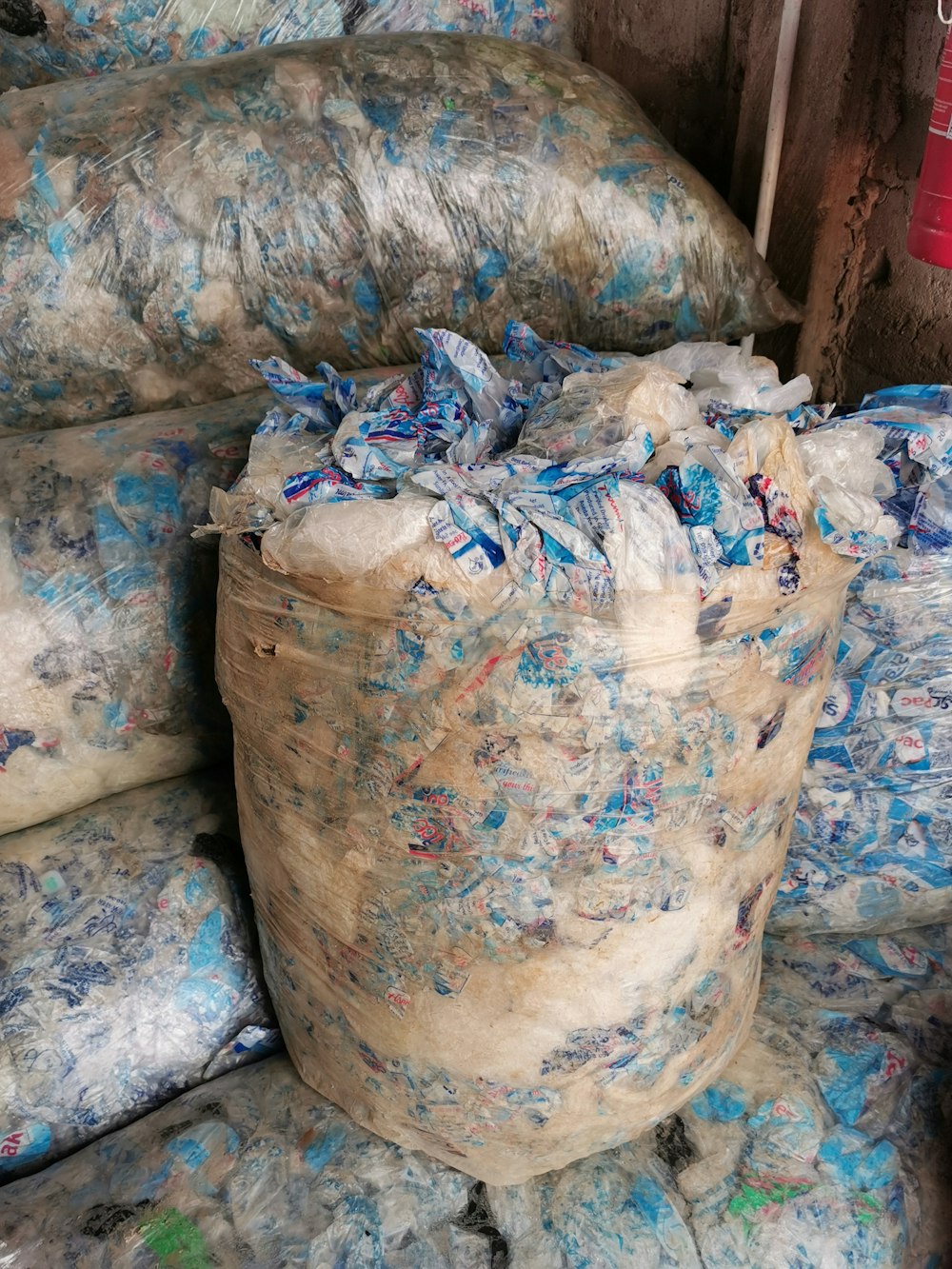 a pile of bags filled with blue and white bags