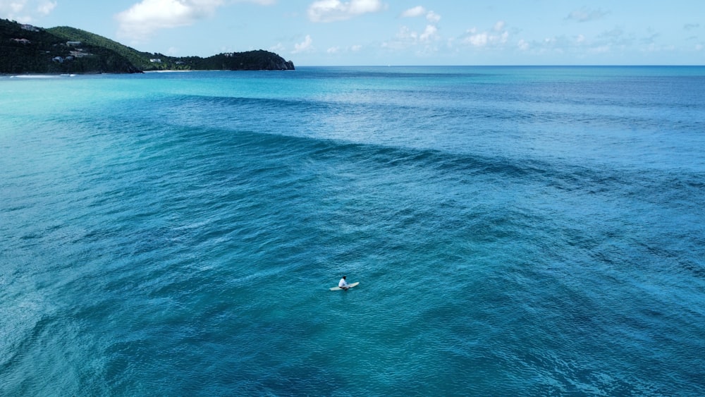 a man riding a surfboard on top of a wave in the ocean