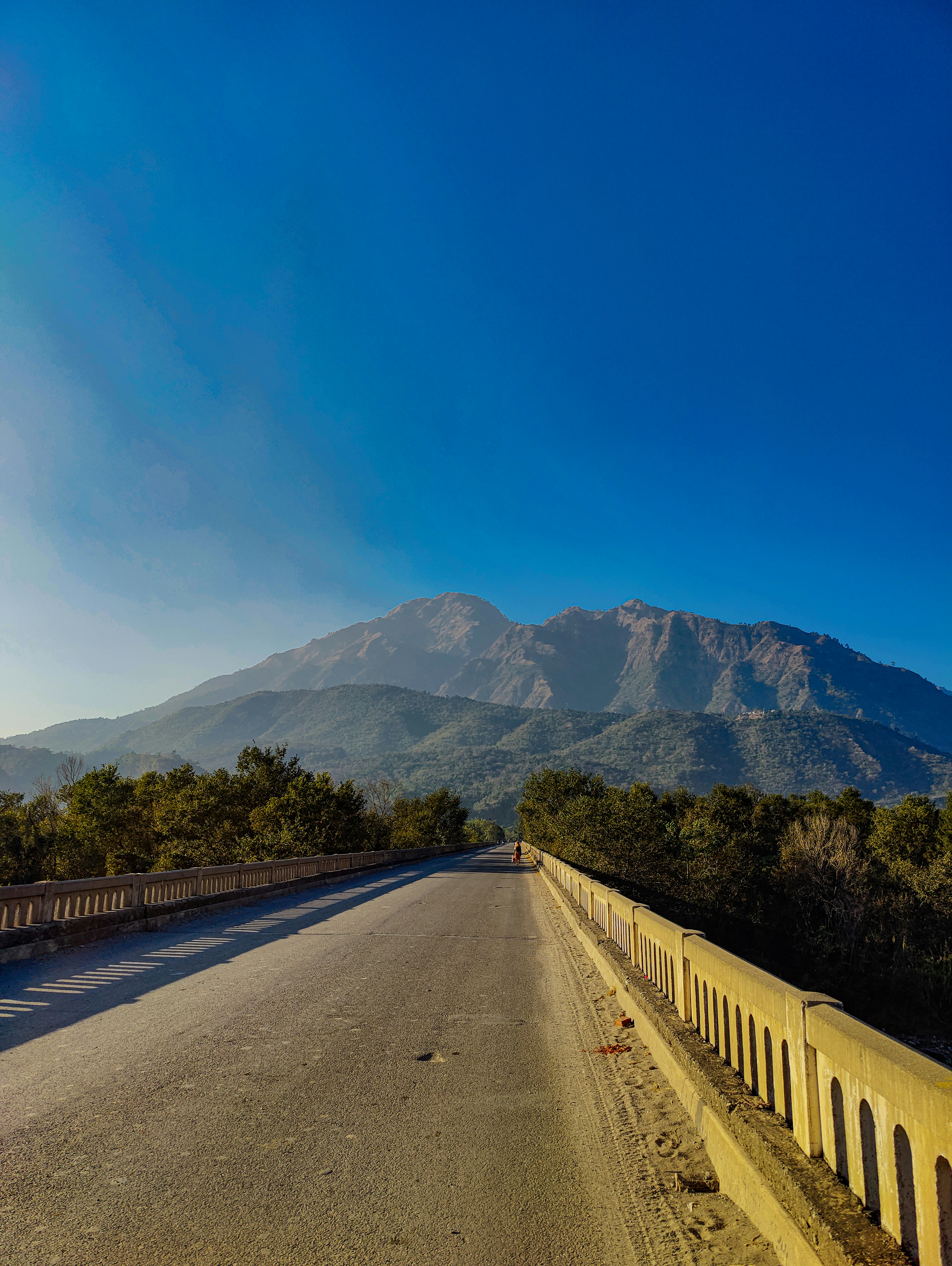 Un camino vacío con una montaña al fondo
