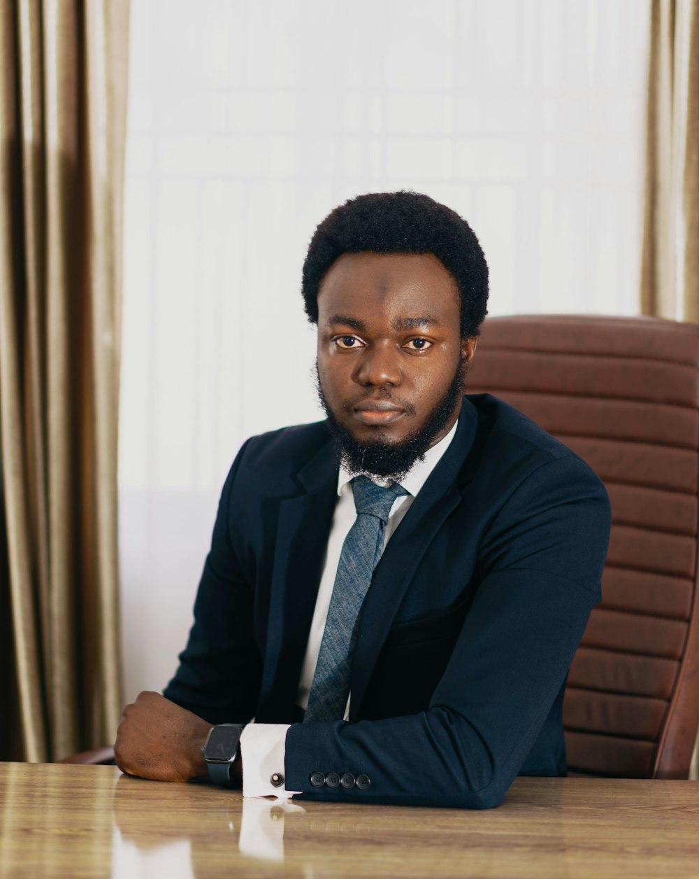 a man in a suit sitting at a table