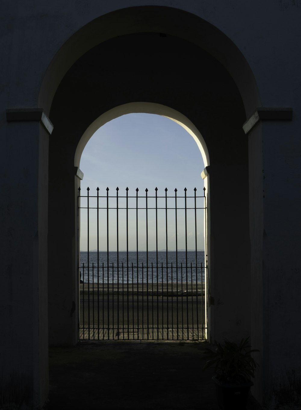 a gate with a view of the ocean through it