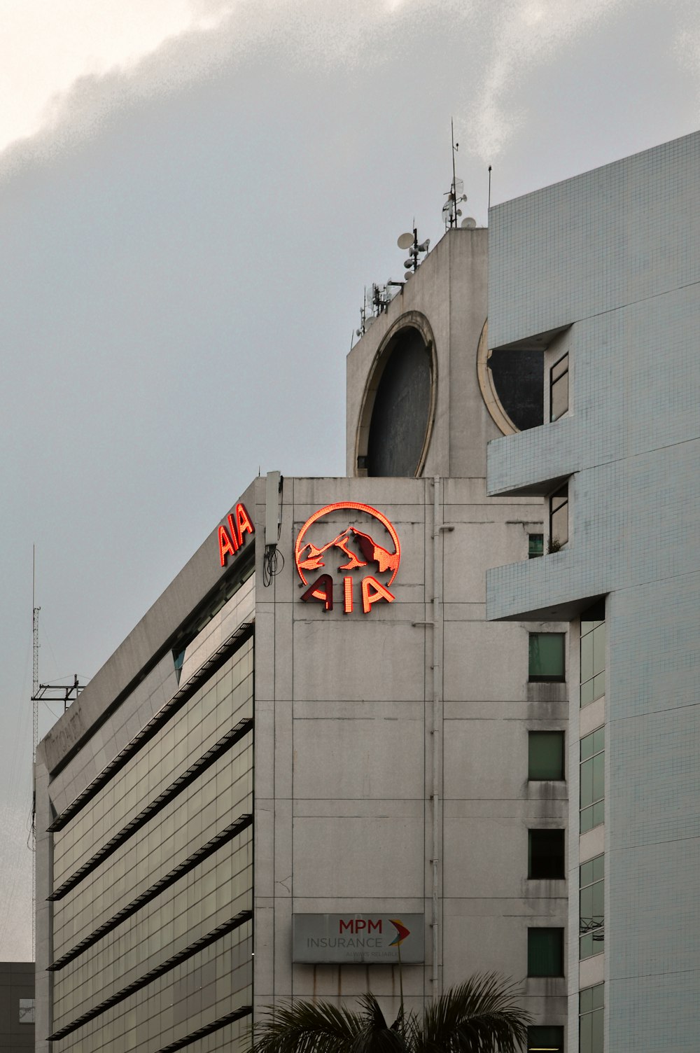 a tall building with a neon sign on it's side